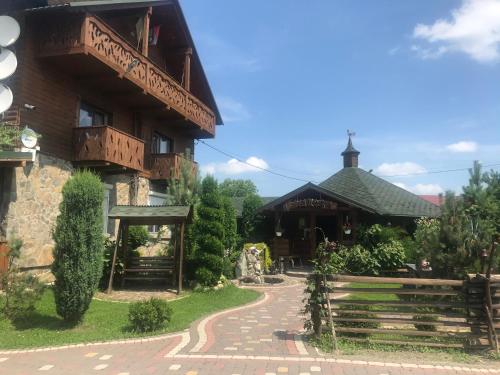 a building with a walkway in front of it at Sadyba Pidkova Чан сауна Приймаємо групи до 70людей in Pistyn