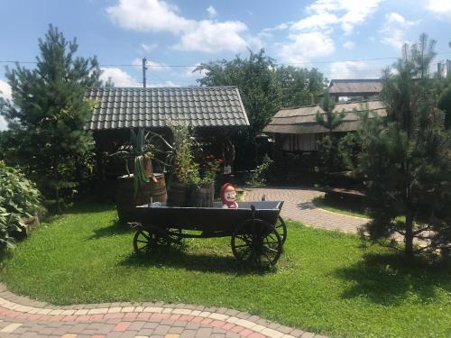 a child sitting in a cart in a yard at Sadyba Pidkova Чан сауна Приймаємо групи до 70людей in Pistyn