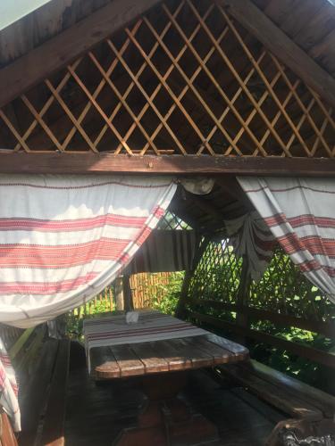 a bed in a tent with a table under it at Sadyba Pidkova Чан сауна Приймаємо групи до 70людей in Pistyn