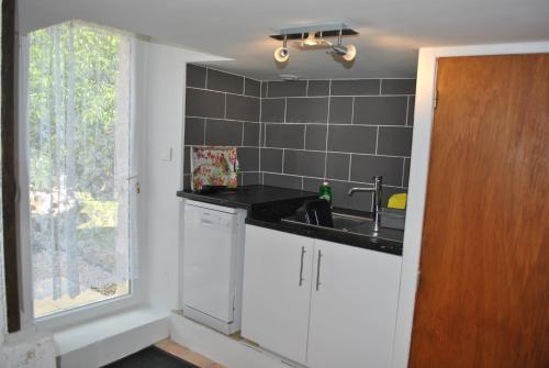 a kitchen with a sink and a window at Maison Belle Vue in Cherval