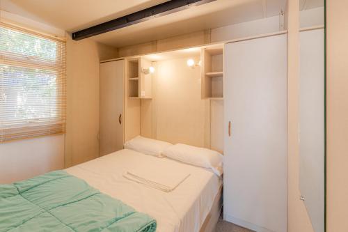 a small room with two beds and a closet at Camping Bon Sol in El Campello