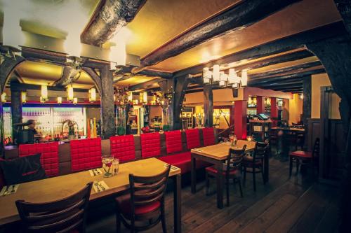 a restaurant with wooden tables and red chairs at Zur alten Krone in Hattingen