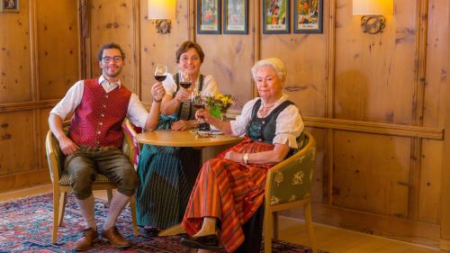 a group of people sitting at a table with wine glasses at Appartement- und Wellnesshotel Charlotte - 3 Sterne Superior in Seefeld in Tirol