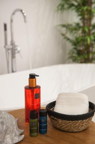 a bathroom with a sink and a basket of towels at Bohemia Luxury Living in Hanioti