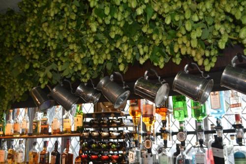 a bar with a bunch of bottles of wine at Mermaid Inn in Rye