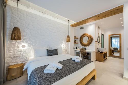 1 dormitorio con 1 cama grande y toallas. en Bohemia Luxury Living, en Chaniotis