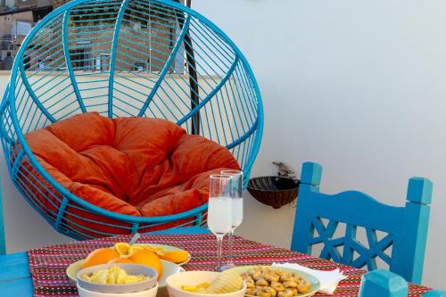 a table with a bird cage and a glass of wine at BnB Sant'Alfonso in Agrigento