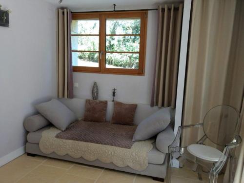 a living room with a couch and a window at La Lezardiere in Gourdon-en-quercy