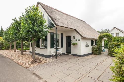 a white house with a roof at Vakantiehuis Villa 32 in Heel