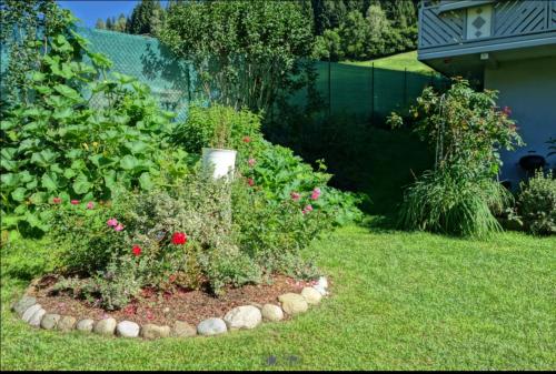a garden with flowers and plants in a yard at Traar Walter und Edeltraut in Scherzboden