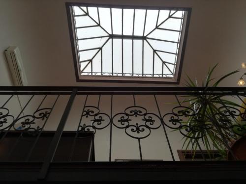 a window on top of a balcony with plants at Hotel Biscari in Catania