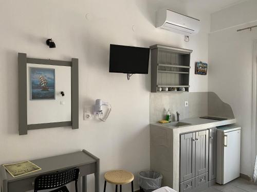 a kitchen with a sink and a counter top at Deep Blue Rooms & Apartments in Mylopotas