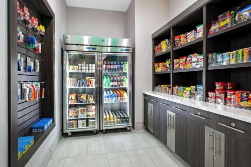 a kitchen with an open refrigerator with lots of food at La Quinta Inn & Suites DFW West-Glade-Parks in Euless