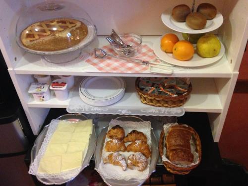 a refrigerator filled with lots of food and desserts at Hotel Chopin in Milan