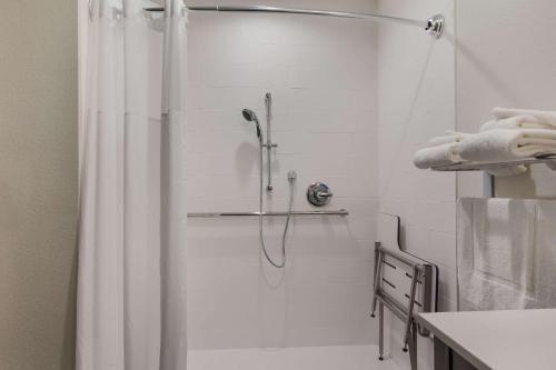 a shower with a shower curtain in a bathroom at Sleep Inn East Camden in Camden