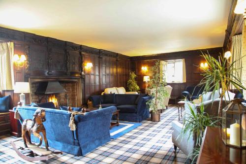 a living room with a blue couch and a fireplace at Mortons Manor in Corfe Castle