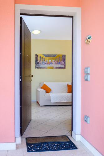 a door leading to a bedroom with a bed at Residenza Il Rivo in Rivotorto