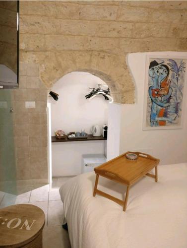 a bedroom with a bed and a table in a room at Abbazia Degli Svevi in Bari