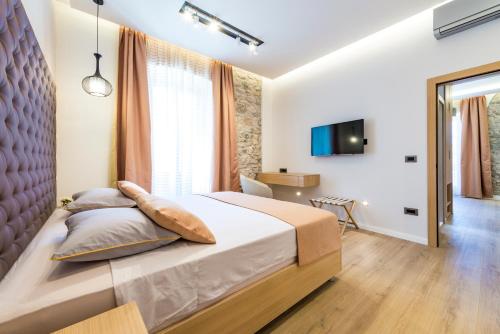 Ένα ή περισσότερα κρεβάτια σε δωμάτιο στο Casa Antika Suites