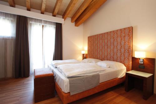 Ένα ή περισσότερα κρεβάτια σε δωμάτιο στο Hotel Lido