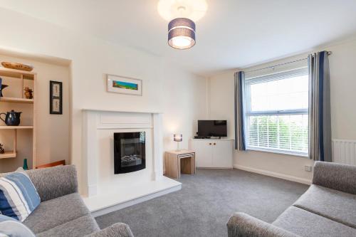 a living room with a couch and a fireplace at CRANBROOK 28 in Nottingham