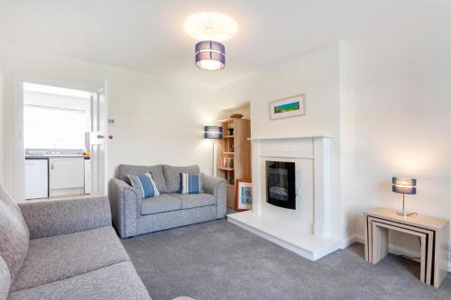 a living room with a couch and a fireplace at CRANBROOK 28 in Nottingham