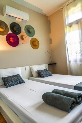 two beds in a room with hats on the wall at Chariklia's House with private pool in Káto Lekhónia