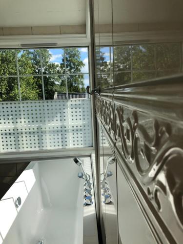 a bathroom with two windows and a view of a sink at Villa Sole, Trysil in Trysil