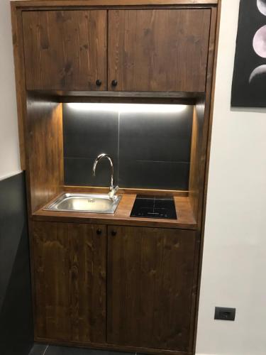 a kitchen with a sink and a stove at Medusa Cilea Guest House in Naples