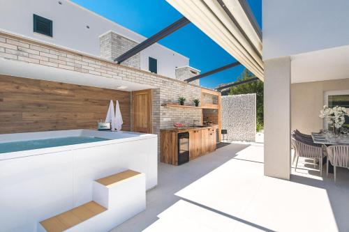 a kitchen and dining area with a hot tub in a house at Villa Aurora in Baška