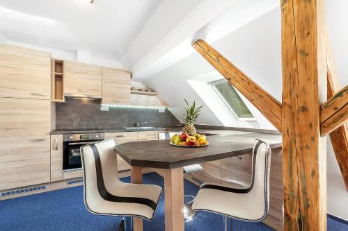 a kitchen with a table with a bowl of fruit on it at Penzion Bačalský mlýn in Morašice