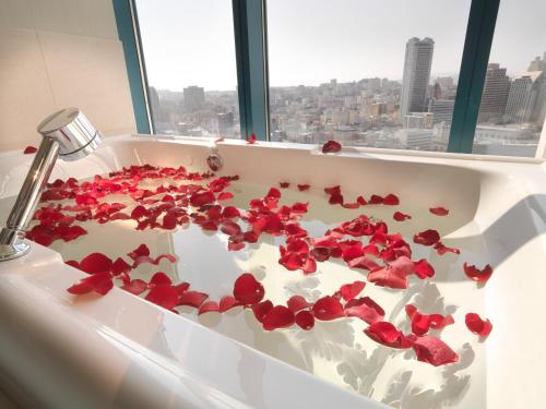 a bath tub filled with red roses in a bathroom at InterContinental San Francisco by IHG in San Francisco