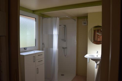 a bathroom with a shower and a sink at Camping La Charderie in Pont-de-Labeaume