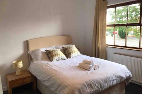 a bedroom with a bed with two towels on it at Bangor Home from Home 2bed house in Bangor
