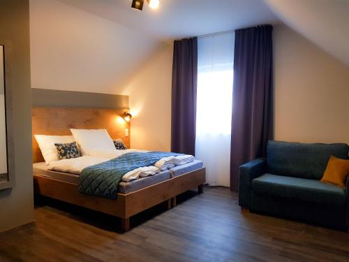 a bedroom with a bed and a chair and a window at Baltic Seaside in Rewal