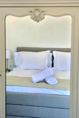 a bed with two towels on top of it at Hydra Art Suites in Hydra