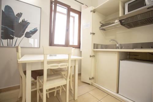 a small kitchen with a table and a sink at Le Plejadi in Castellammare del Golfo