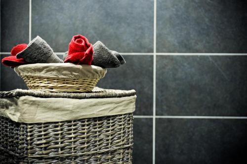 two baskets with towels on top of a tiled wall at Le Saint-Pierre in Mézidon-Canon