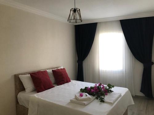 ein Schlafzimmer mit einem Bett mit Blumen darauf in der Unterkunft Apart TU Çeşme in Izmir