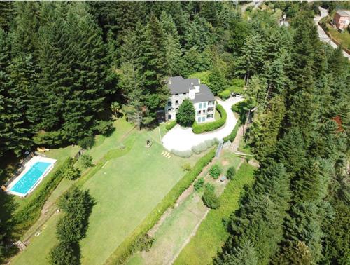 an aerial view of a large house with a swimming pool at Il Bosco di Campo Marzano studios in Borzonasca