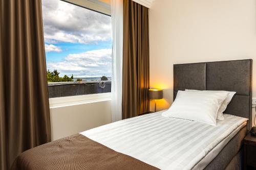 Postel nebo postele na pokoji v ubytování Adoryal Hotell