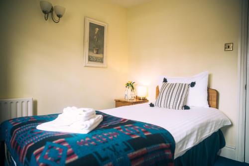 a bedroom with a bed with a blanket on it at The Old Bakery in Kenilworth