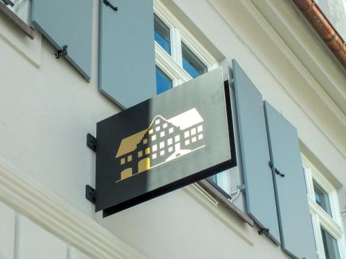 a sign for a building on the side of a building at Hotel & Restaurant Posthalterei in Zusmarshausen