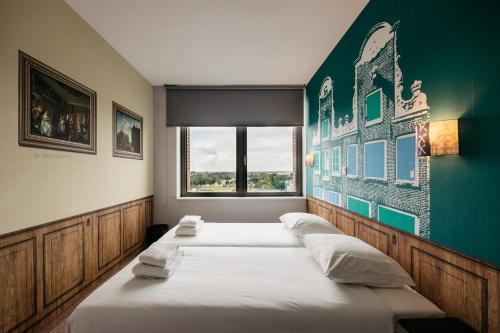 Amsterdam ID Aparthotel tesisinde bir odada yatak veya yataklar