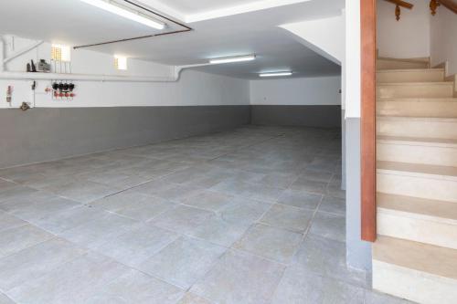an empty basement with a staircase and a tile floor at Myhost Augusta Altafulla in Altafulla