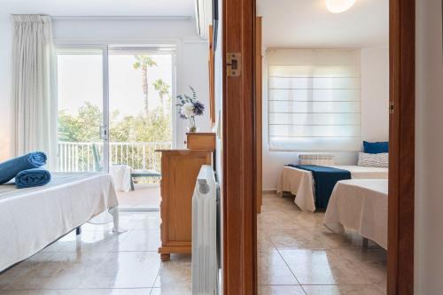 a bedroom with two beds and a window at Myhost Augusta Altafulla in Altafulla
