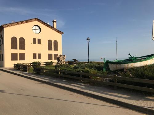 a building with a boat on the side of a street at Myhost Augusta Altafulla in Altafulla
