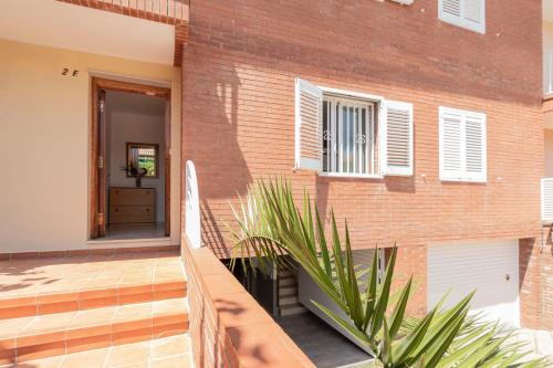 a house with a porch and a brick building at Myhost Augusta Altafulla in Altafulla