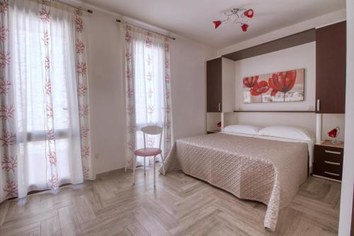 a bedroom with a bed and a chair in it at Residence Il Corallo - Guitgia in Lampedusa