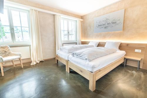 a bedroom with two beds in a room with windows at Drei Könige in Entlebuch